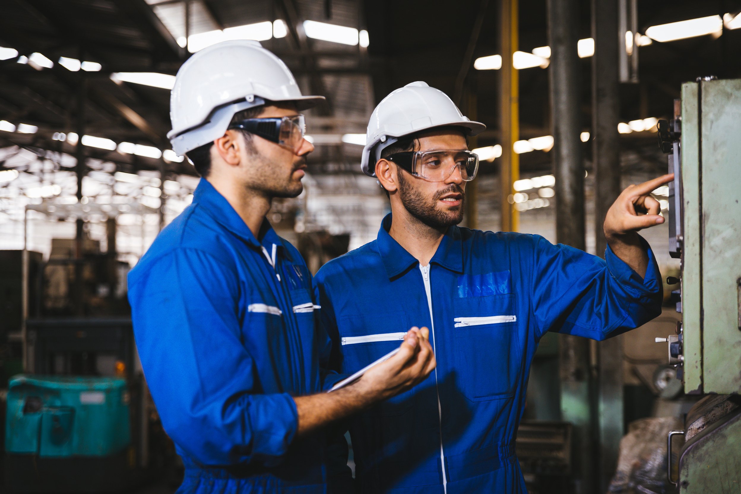 Group of Industrial factory maintenance engineers inspect relay protection system of machinery. Industry, Maintenance, Engineering and construction concept.